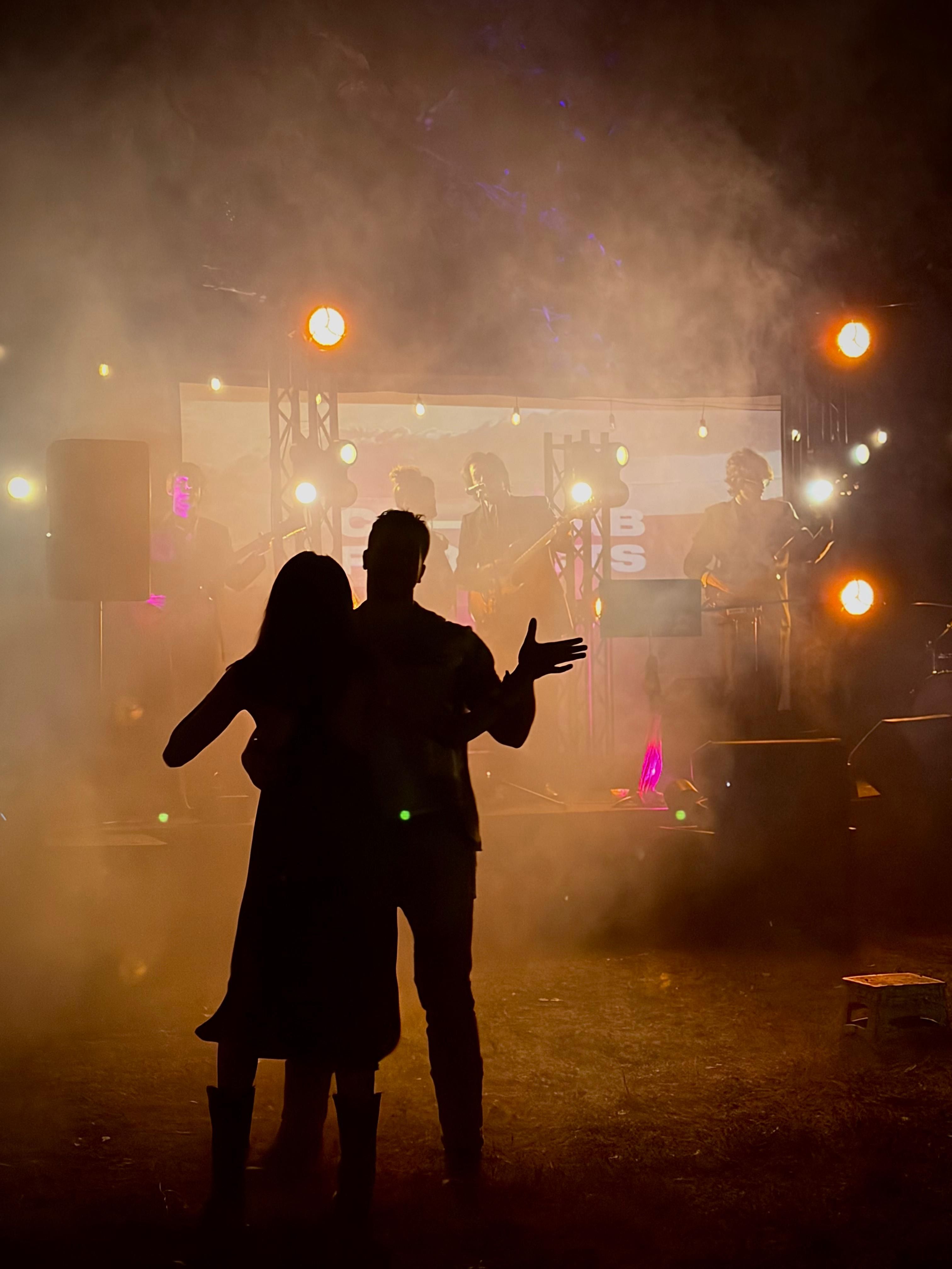 String lights over a dance floor at a barn venue