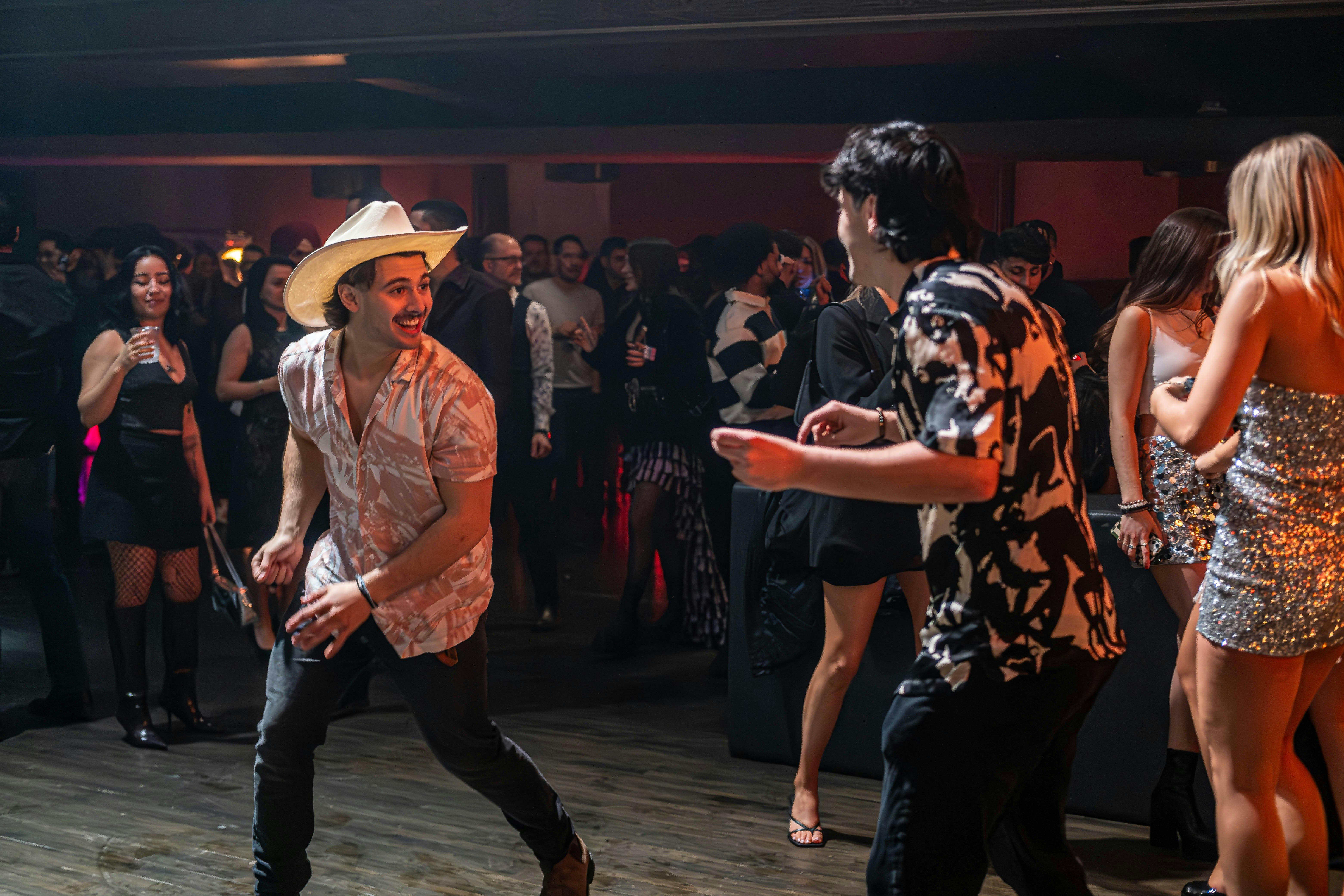 A crowd dancing at an Austin nightclub in cowboy hats