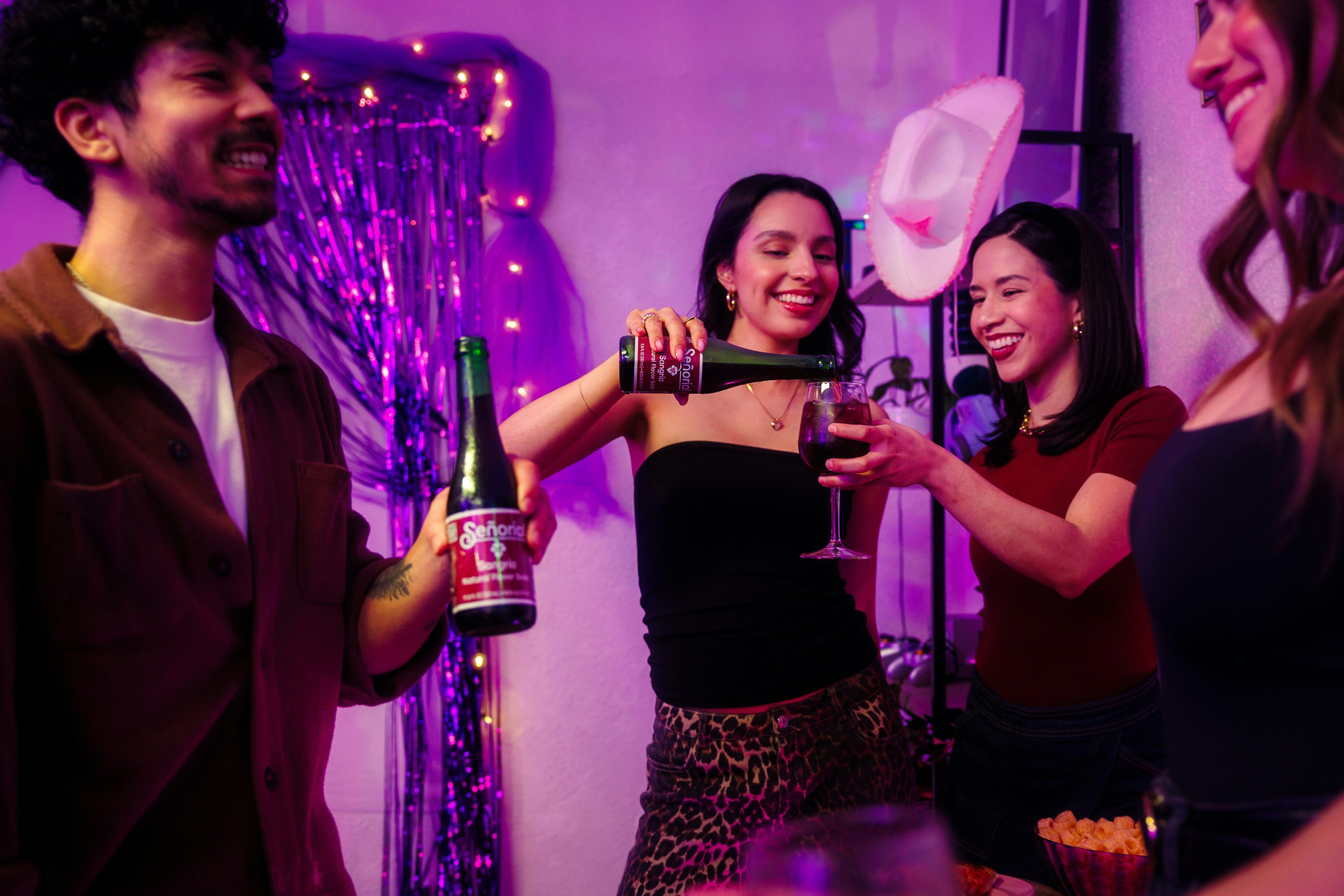 Friends enjoying drinks and food with cowboy hats